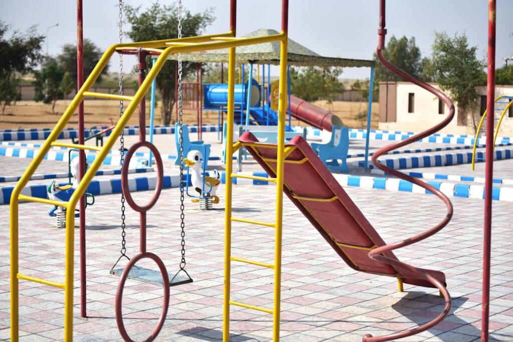 Vibrant playground with slides and swings in outdoor park setting.